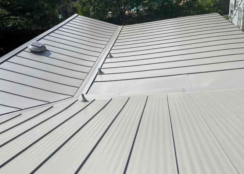 Solar attic fan installed on a metal roof for Roof Ventilation in Magnolia